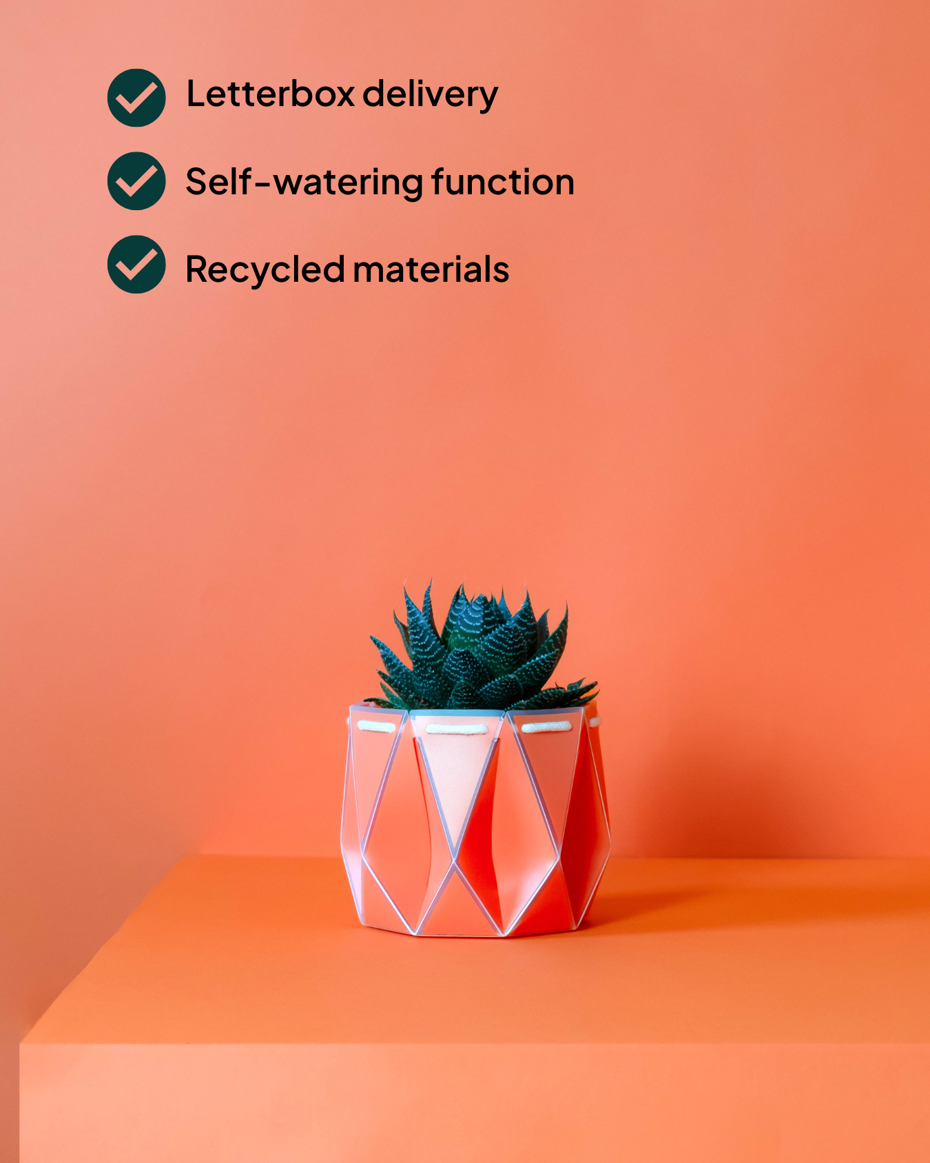 11cm Coral POTR pot with a succulent on an orange pedestal. Three checkmarks list key features: letterbox delivery, self-watering functionality, and recycled materials.